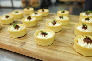 Gorgonzola mousse canapé topped with whipped quince paste and lemon thyme garnish