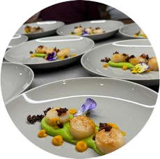 Seared scallops with puree and edible flowers plated by HLB Catering private chef in Melbourne