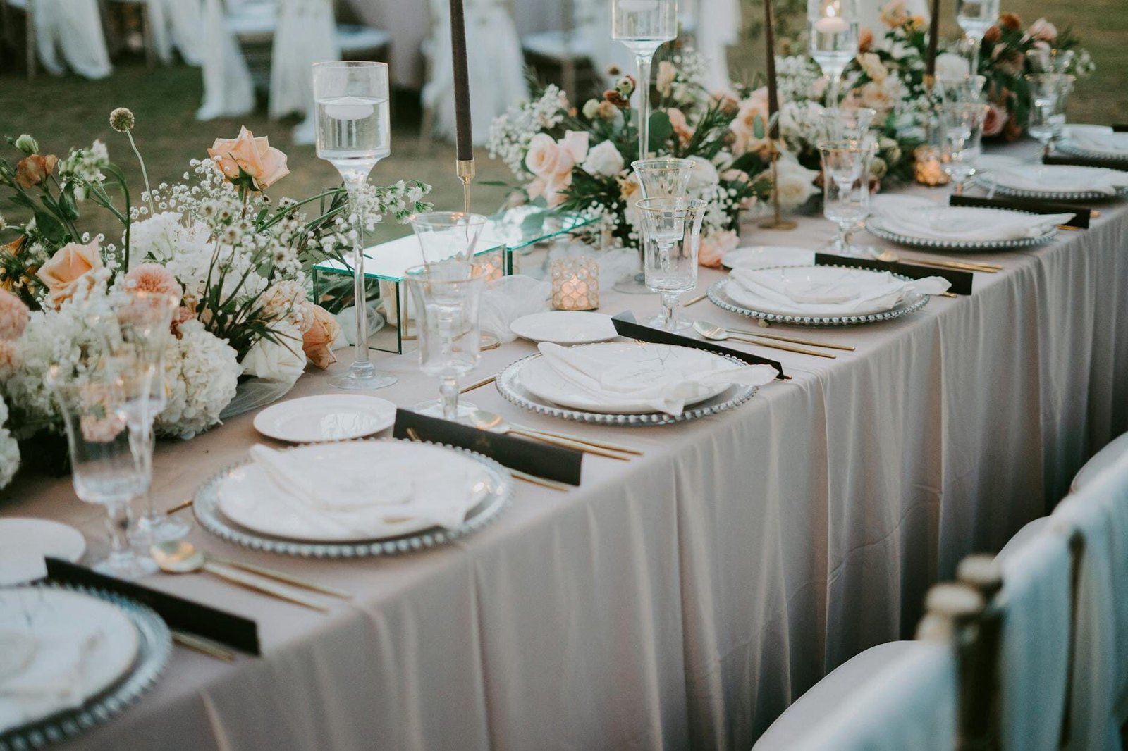 Elegant plated meal table setting Melbourne wedding catering long table crystal glasses gold cutlery white porcelain